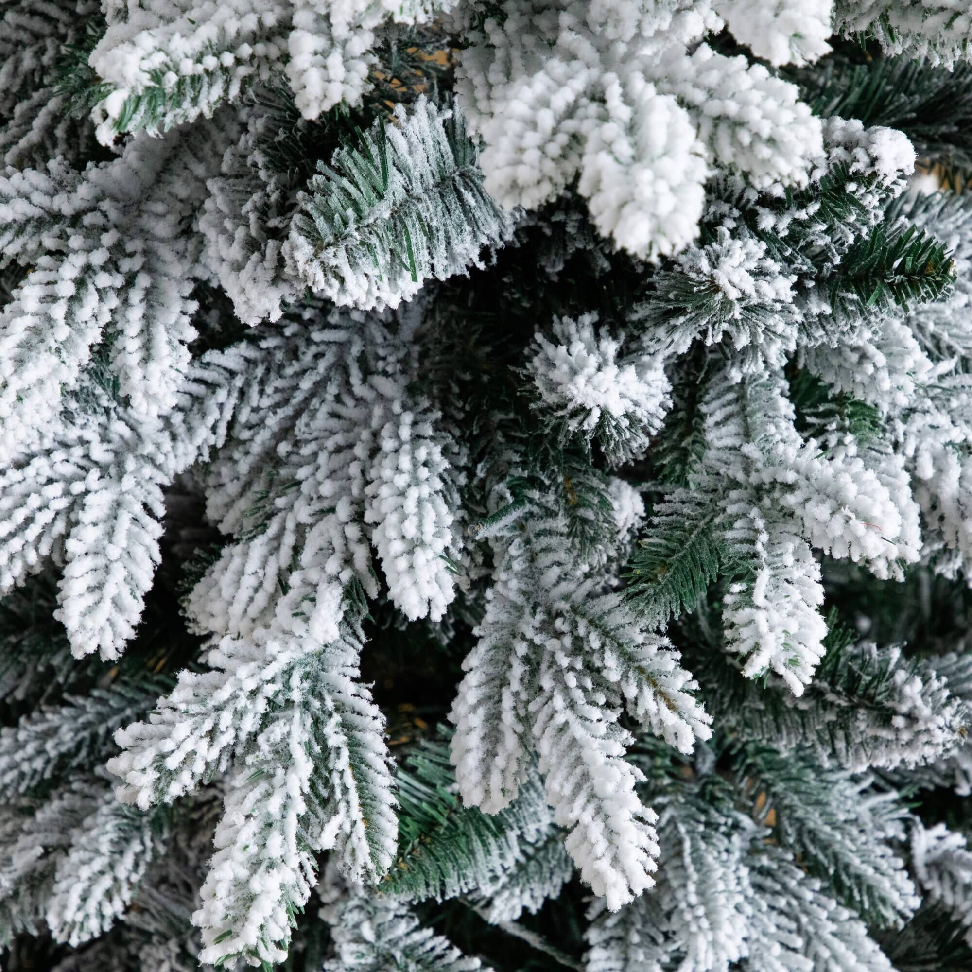 4ft. Pre-Lit Flocked Artificial Christmas Tree in Black Decorative Planter, Warm White LED Lights